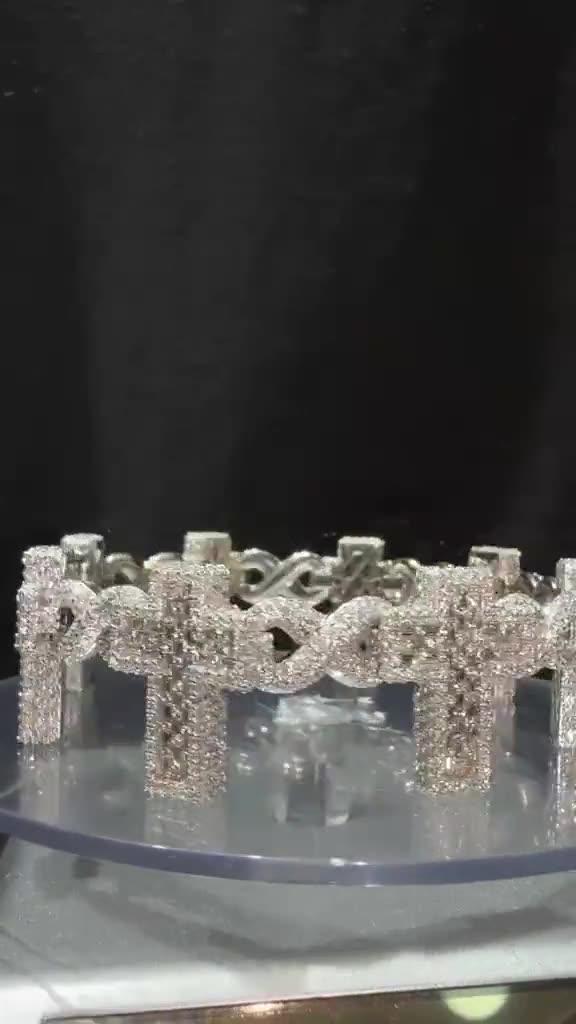 Diamond Cross Charm Infinity Bracelet — 18ct white gold infinity links hung with pavé cross charms