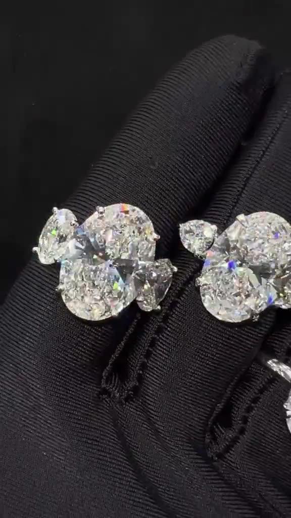Oval Three-Stone Diamond Ring — oval brilliant centre with pear-cut sides, on a slim pavé band